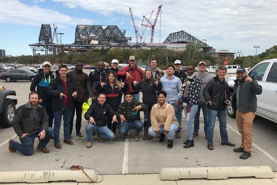 O U Construction Science students in front of a stadium construction site.