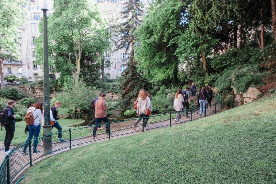 A group of students walking through an urban park
