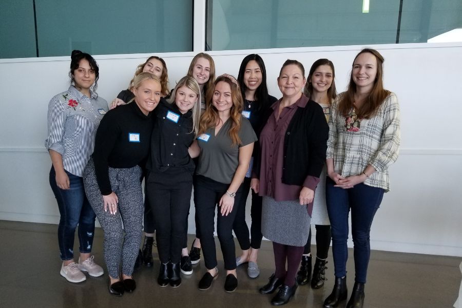 A group of students and their professor posing for a picture