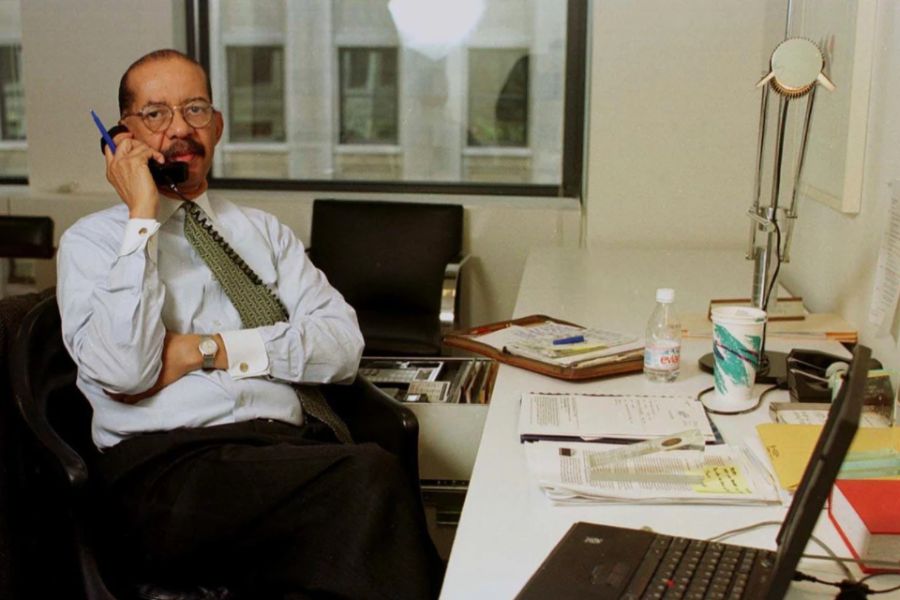 Robert L Wesley in office sitting at desk, talking on phone