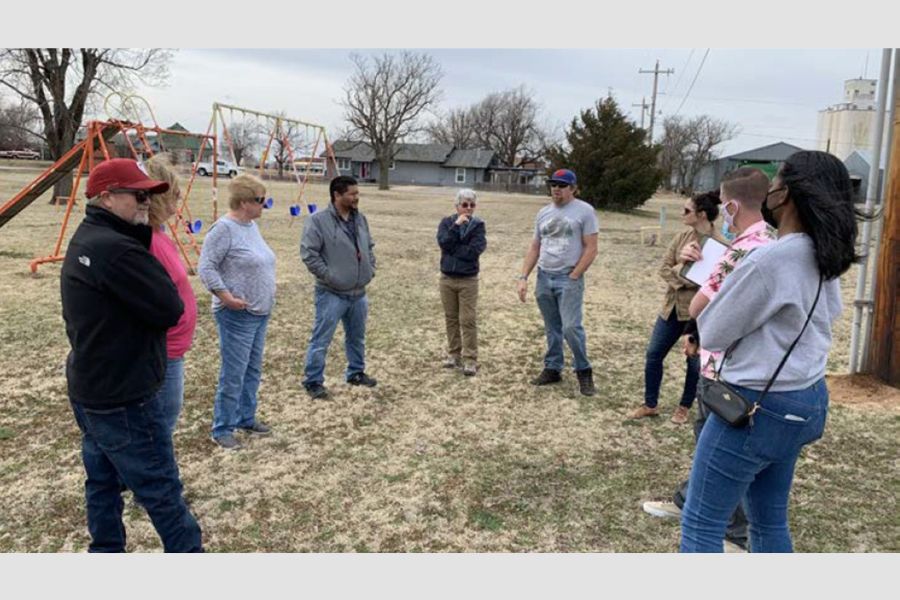 A group of people in a park during a site visit.