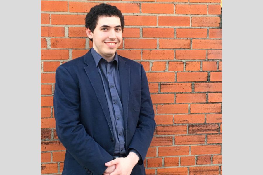 Picture of Donovan Linsey against a red brick wall. 