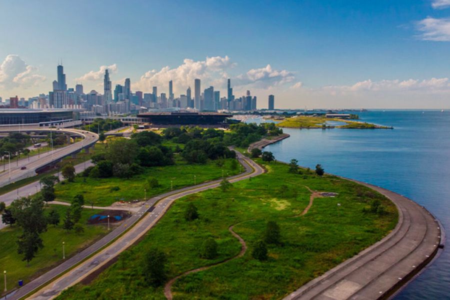 Skyline picture of Chicago with park by Lake Michigan in foreground.