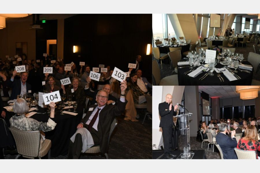 Bidders during a live auction, place settings, and Dean Hans Butzer leading applause.