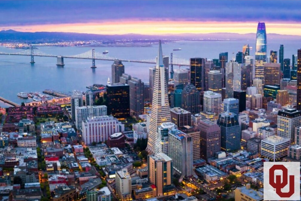 An aerial view of San Francisco with a small O U logo in the corner.