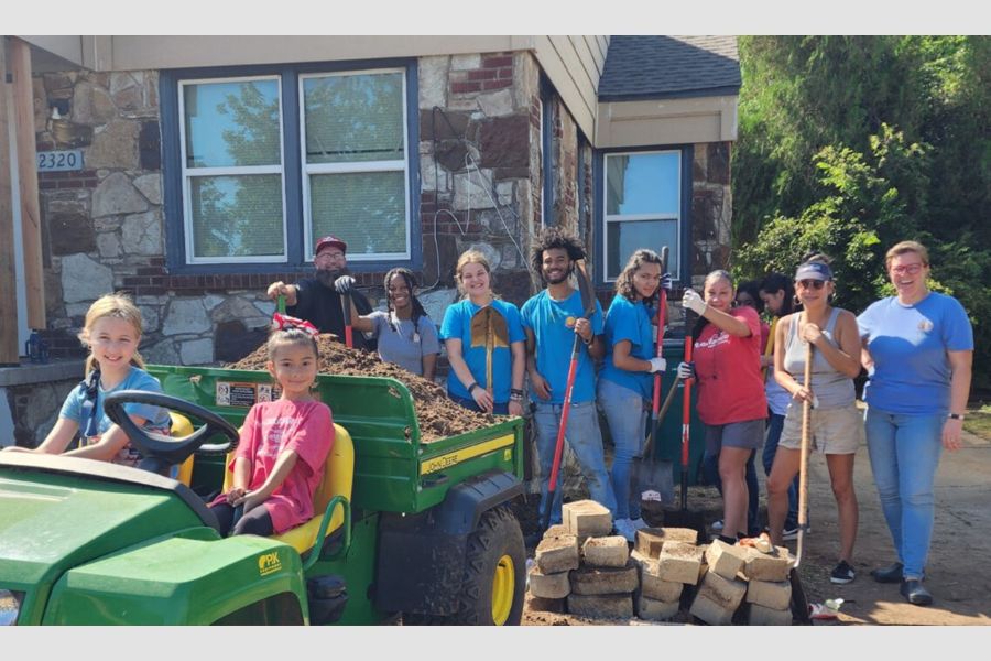 Volunteers from Restore O K C outside of a house.