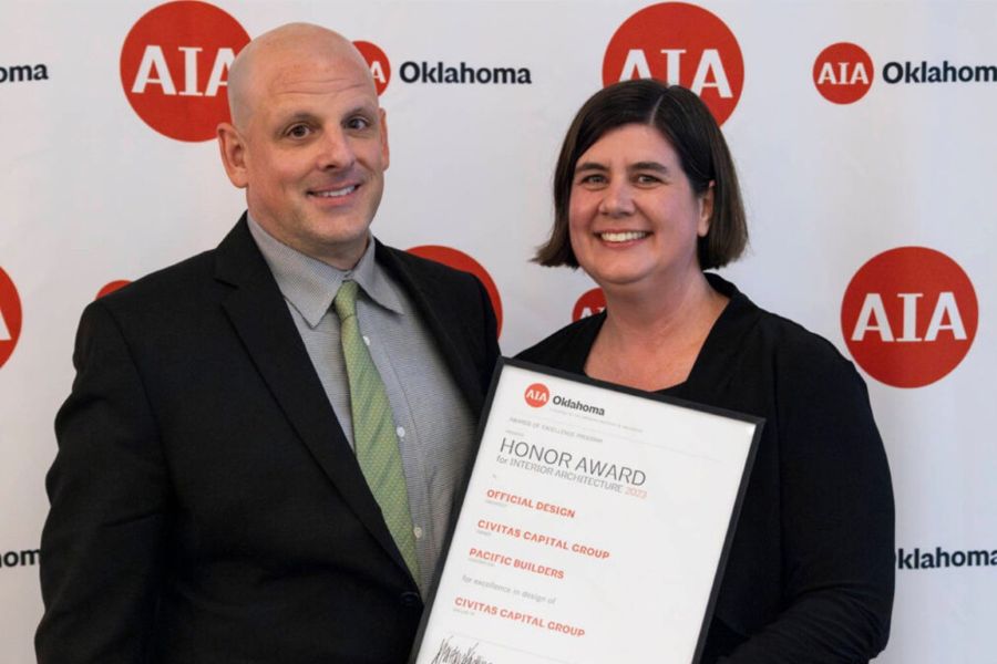 Mark Leveno and Amy Leveno with an award from A I A Oklahoma.