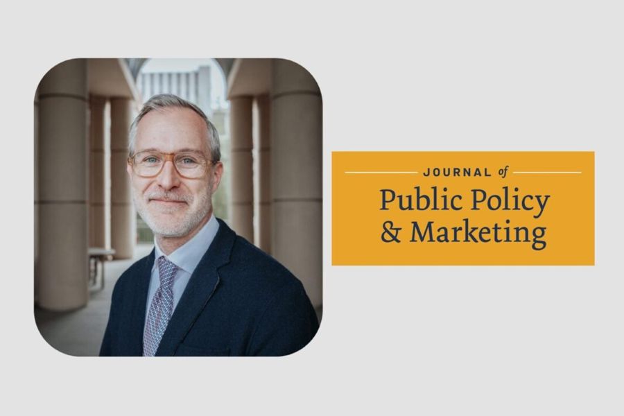 Bryce Lowery with the logo for the Journal of Public Policy and Marketing.
