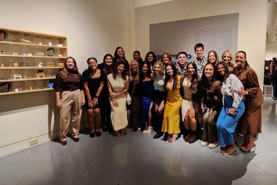 Interior Design students posing for a group photo at the furniture design studio showcase.