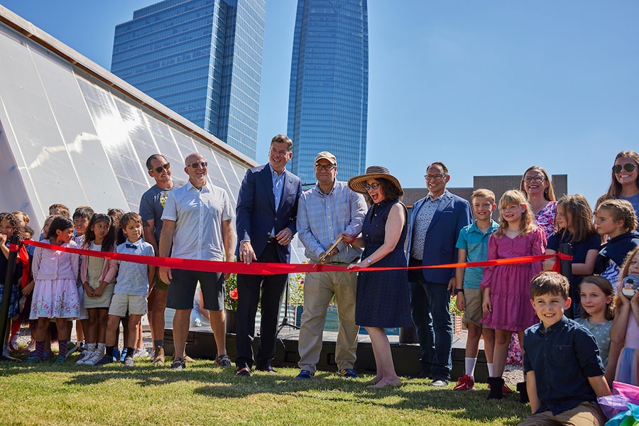 A ribbon cutting for the greenhouse and garden built by O U students.