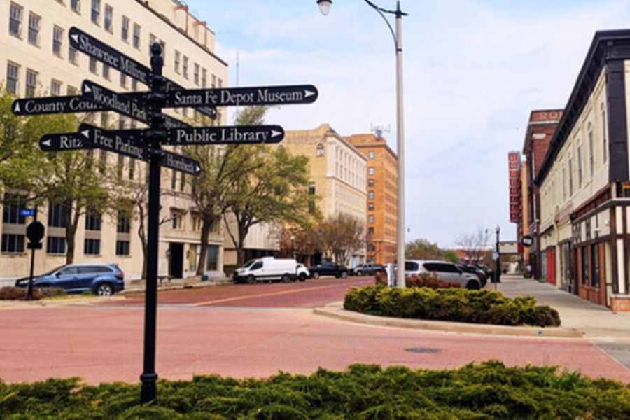 Downtown Shawnee Oklahoma, with a sign pointing towards the public library, Santa Fe Depot Museum, and other attractions.