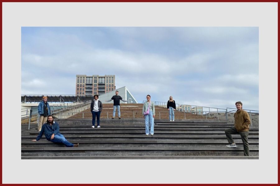 Architecture students posing on steps leading to an art museum.