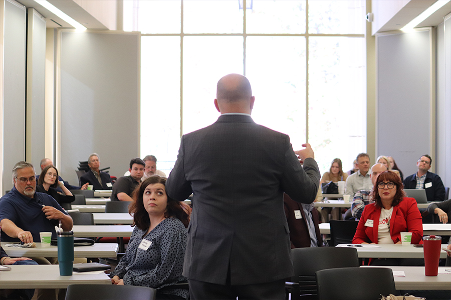 Man addressing event crowd.