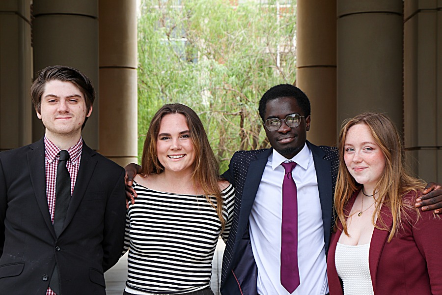 Four O U students standing outside of Gould Hall. 