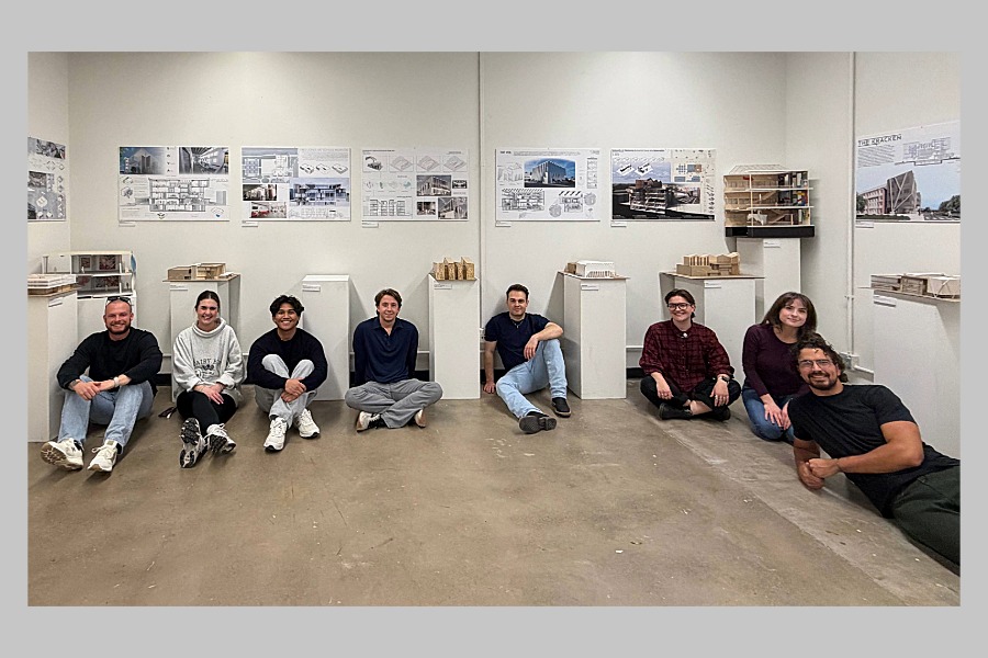 Graduate Architecture students sitting on the floor at the Visual Arts exhibit. 