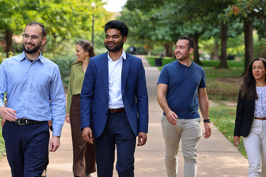 O-U graduates walking around campus together.