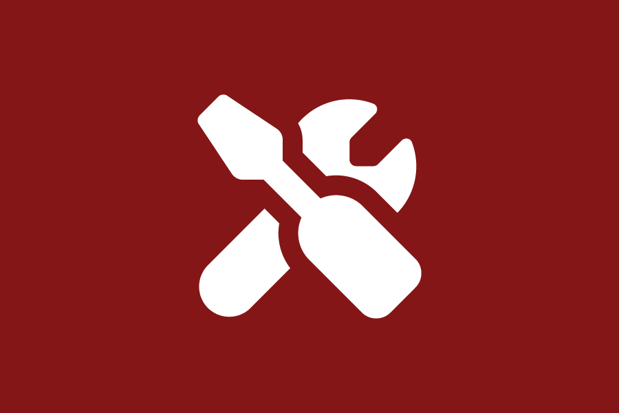 A white screwdriver and wrench icon on a crimson background.