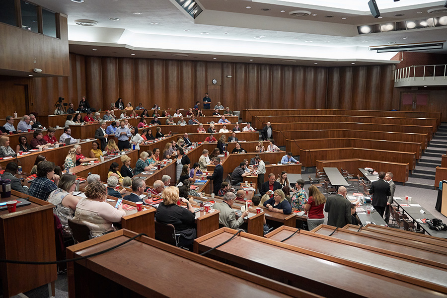 People attending a workshop inside of a lecture hall.
