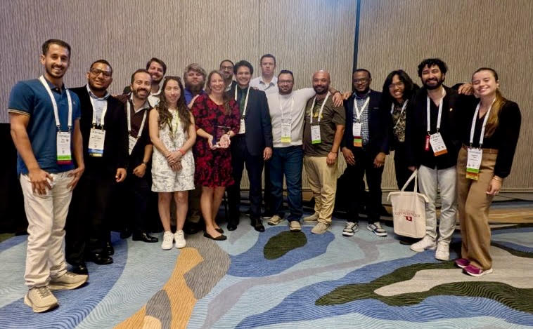 The AASPI group standing in a classroom.