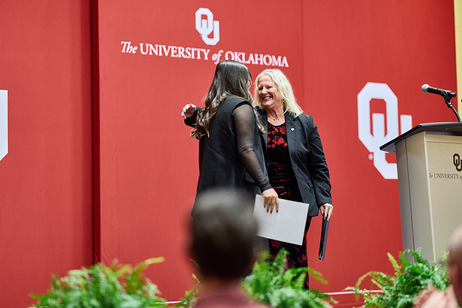 Two people embracing on the stage. 