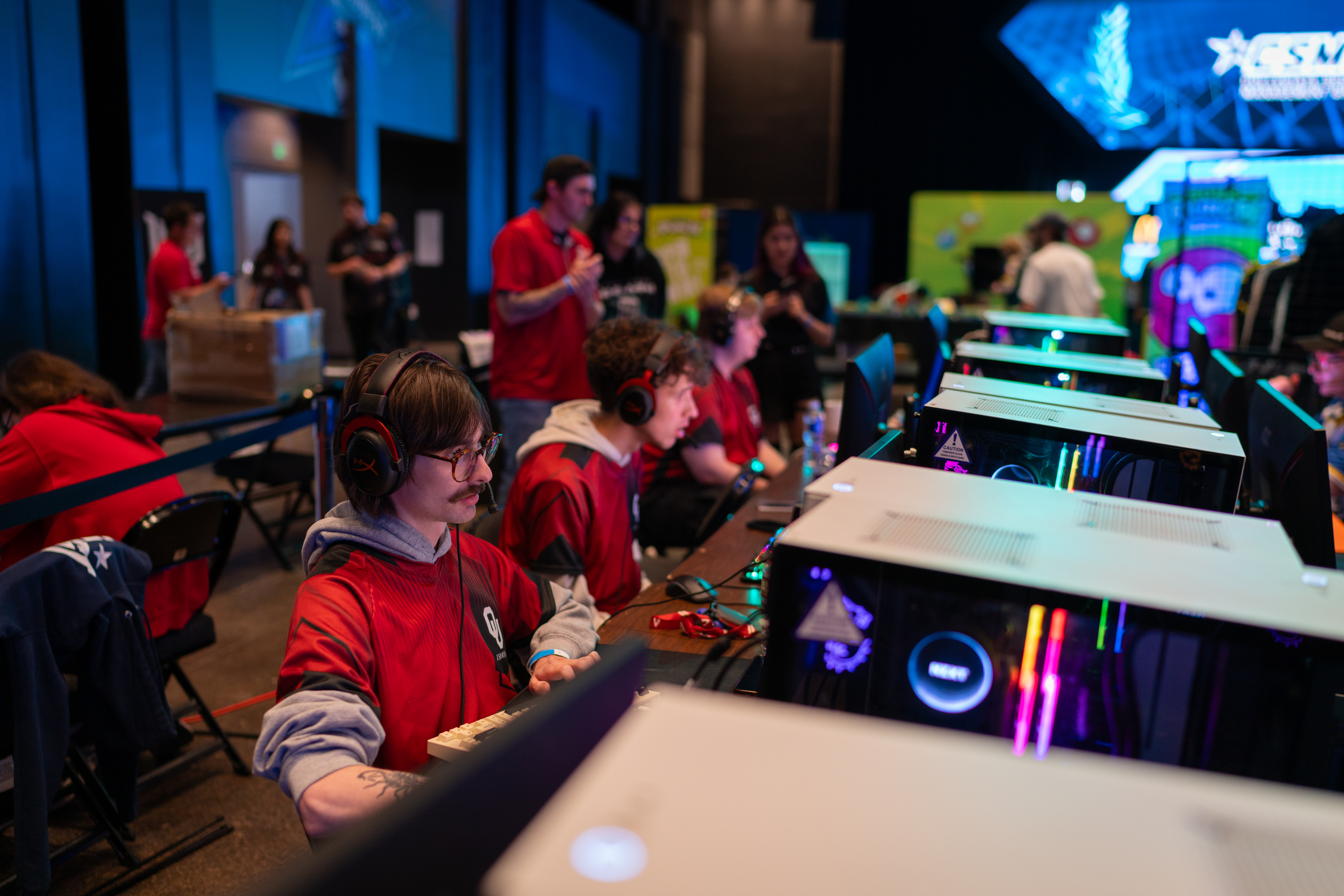 Members of the OU esports community sitting at their computers.
