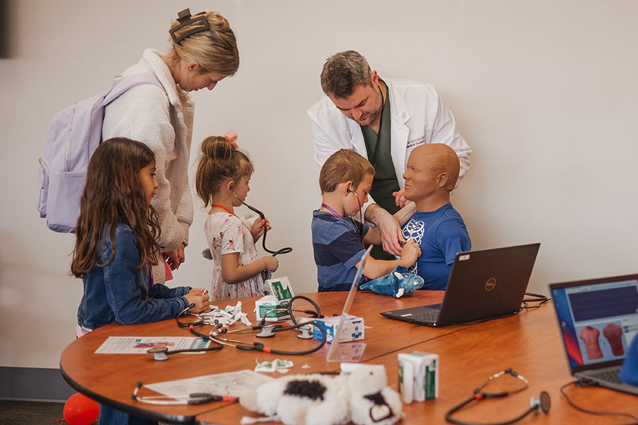 participants checking simulated patient's vital signs.