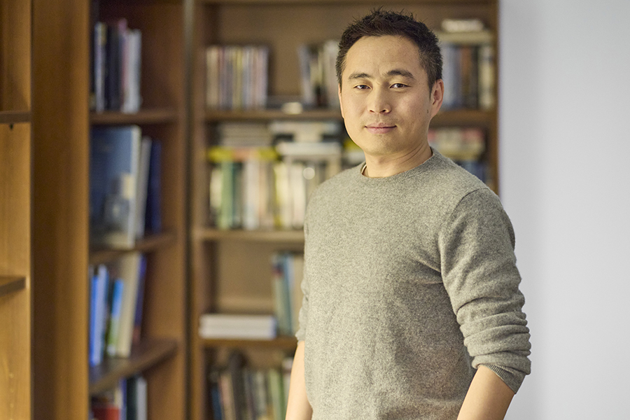Man standing in front of bookcases.