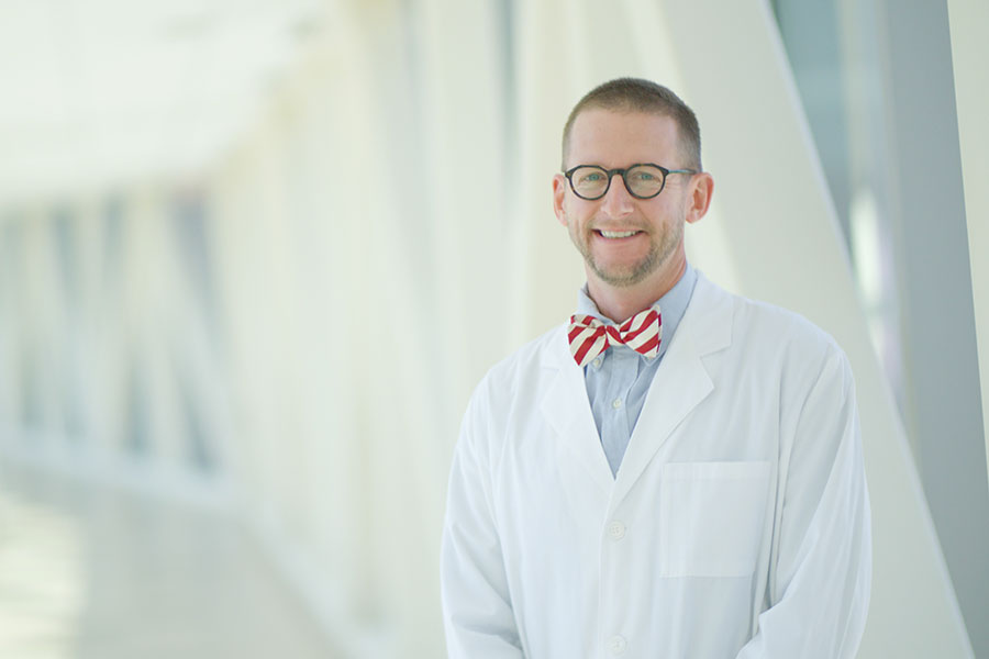 T.R. Lewis stands in a hallway.