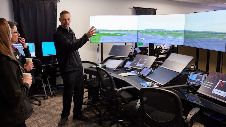 A man pointing at screens.
