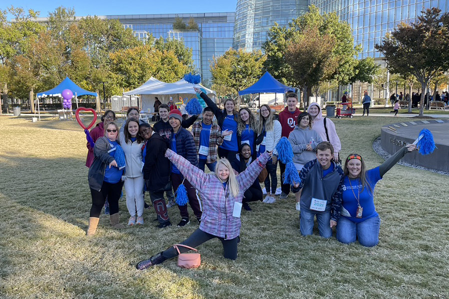 A group of people posing outside.