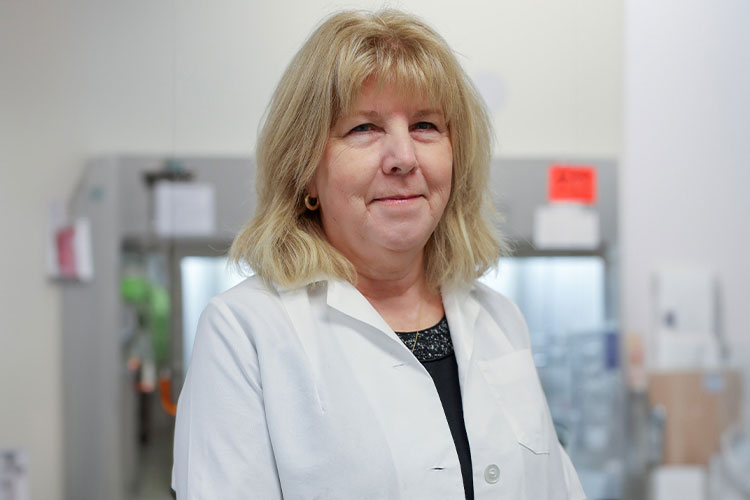Carol Webb standing in a lab. 