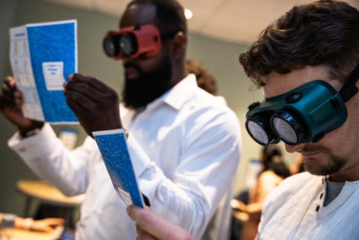 People using goggles to understand accessibility needs in the classroom.