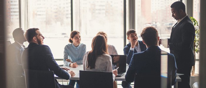 group of coworkers sitting around a conference table