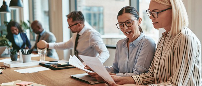 coworkers at a conference table working 
