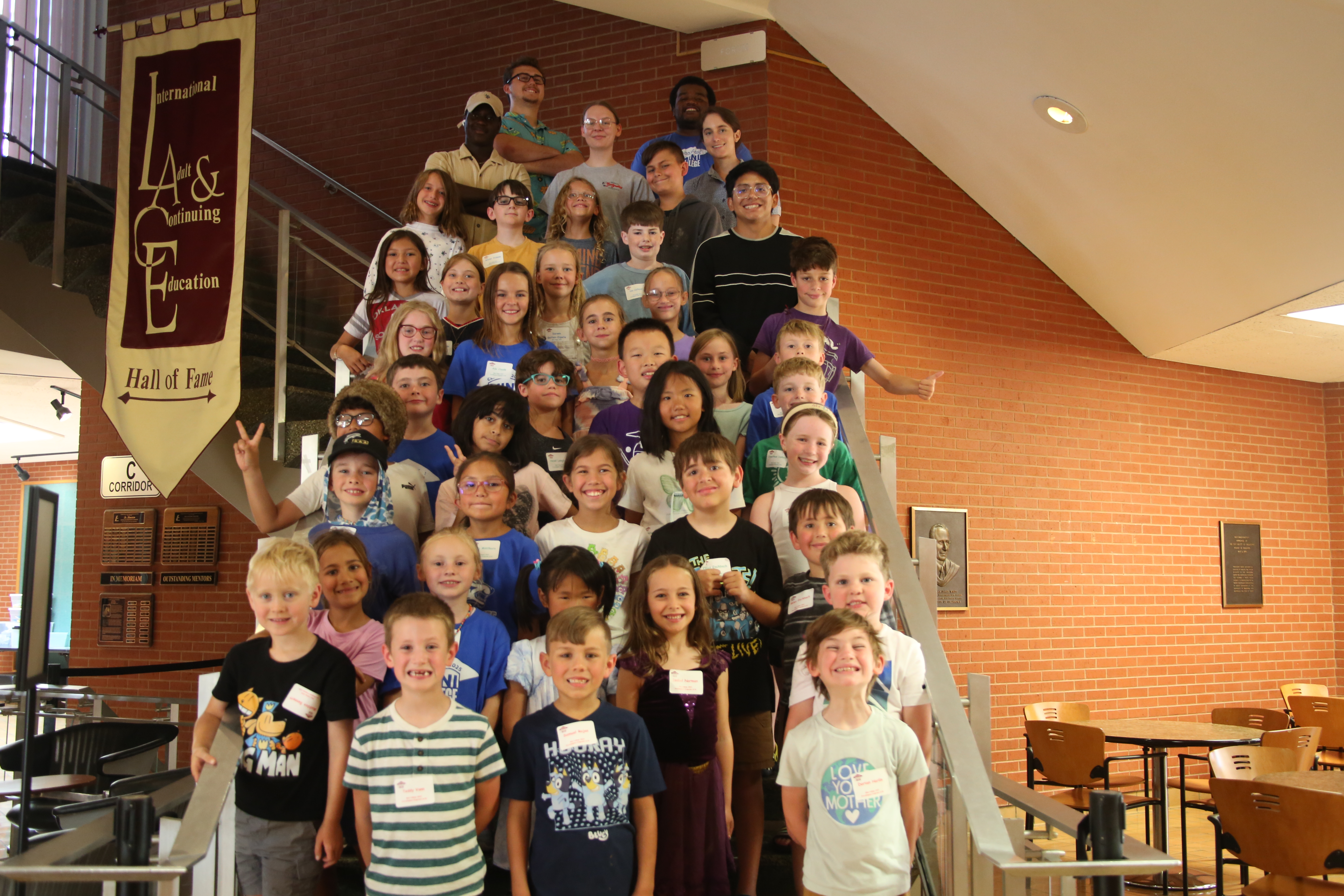 Kids posing for a photo on the stairwell in the forum building.