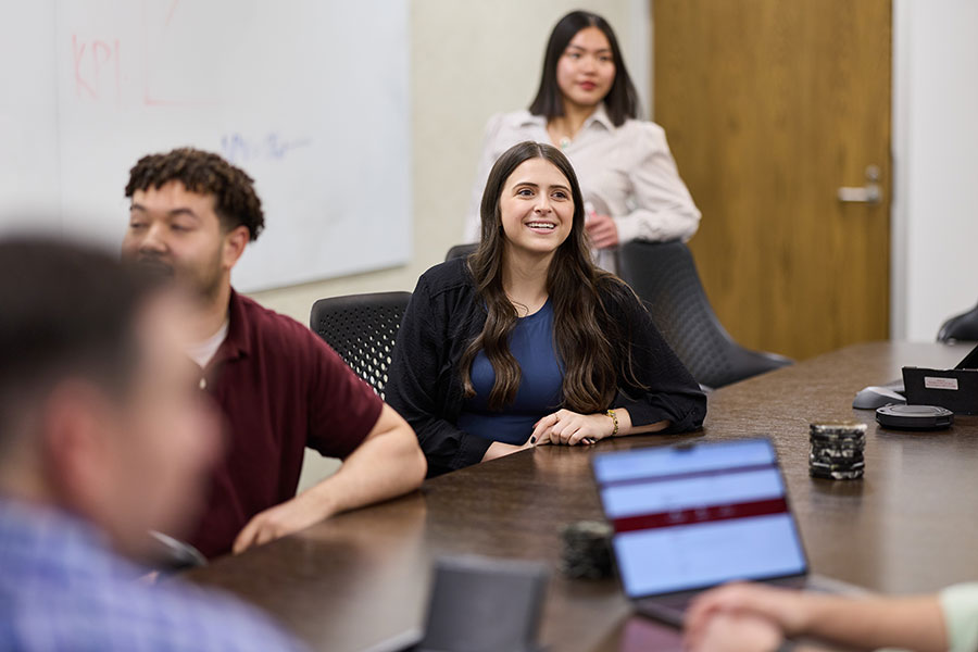 Students in graduate program collaborating in a small group.