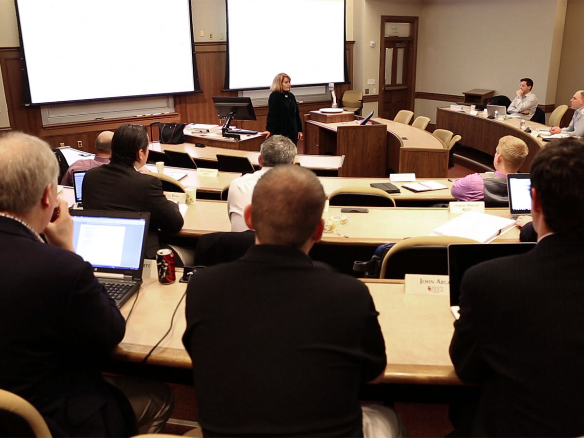 a group of energy professionals in a lecture hall listening to a speaker.