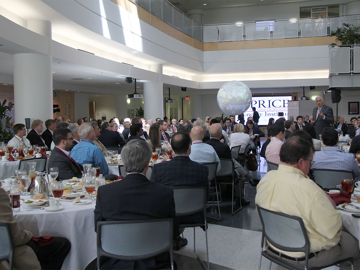 Energy professionals sitting together during a presentation at an energy symposium event.
