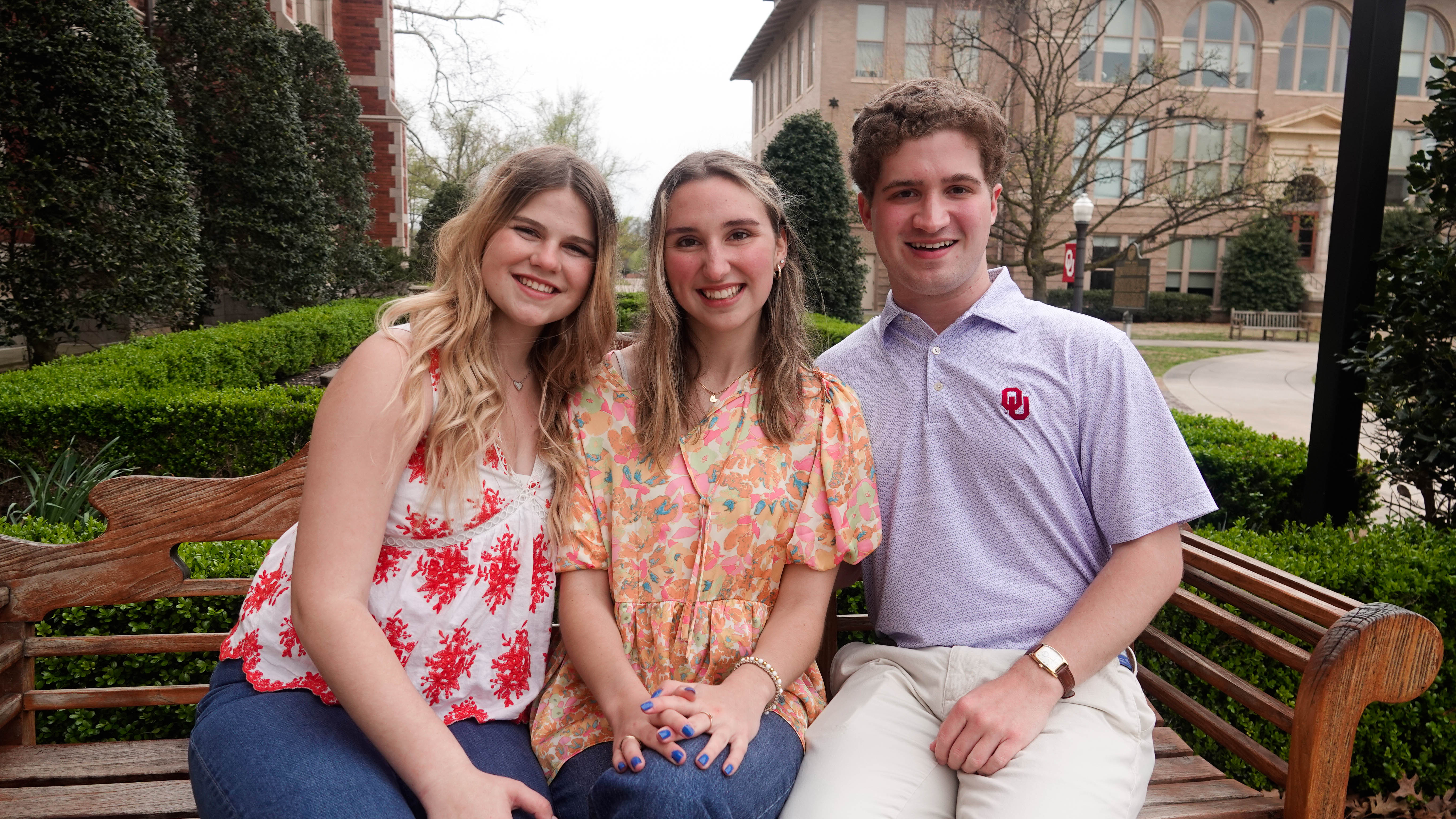 Three students in business casual clothing.