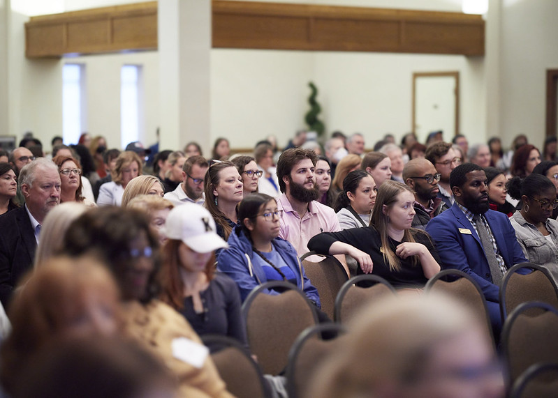 Staff watching award ceremony.