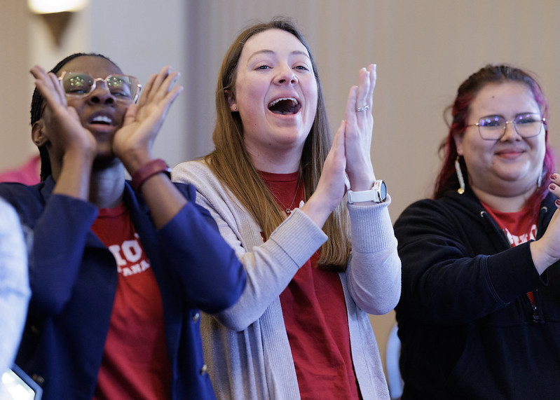 Staff cheering at awards ceremony.