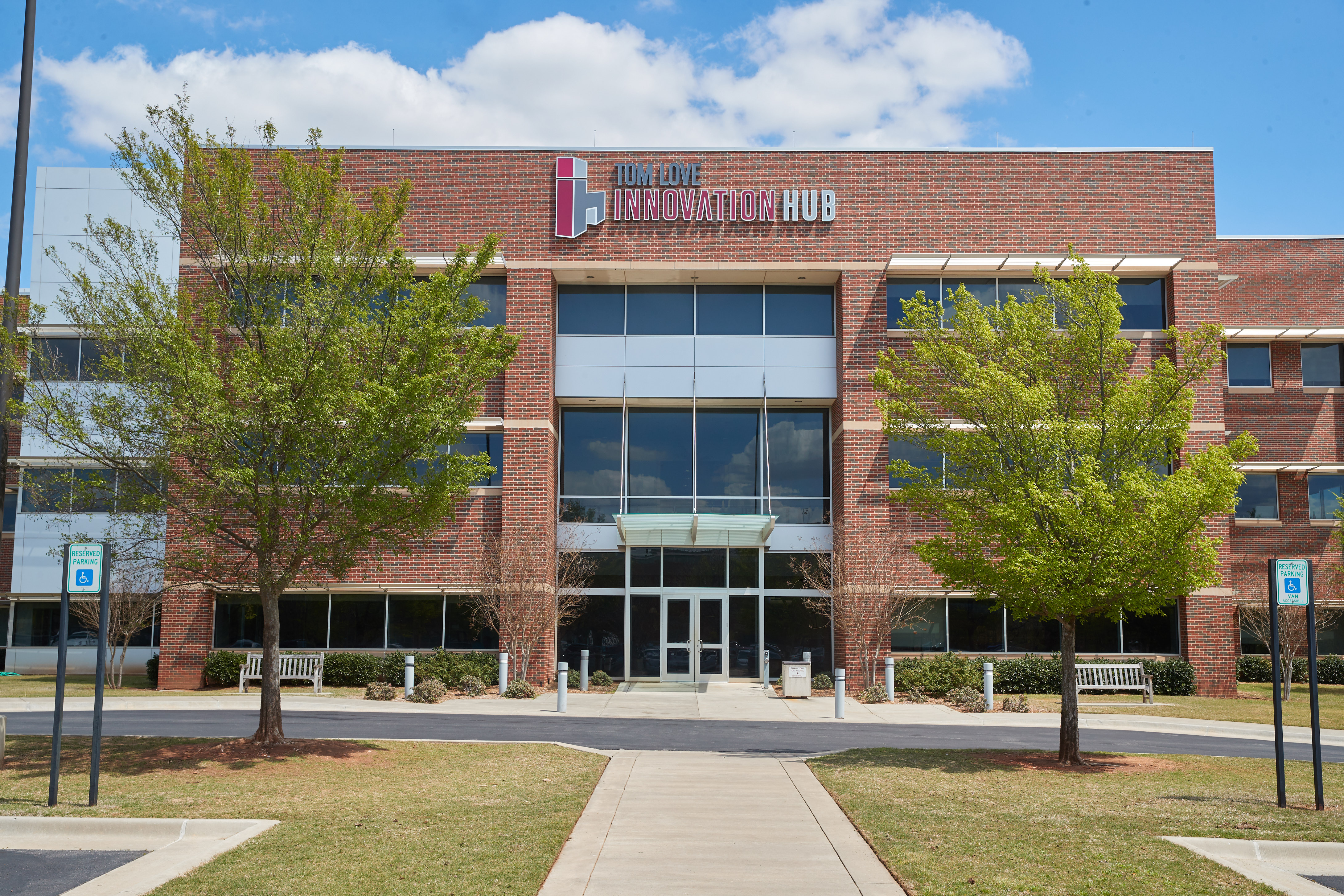 A team works together on a project with a large projection screen.